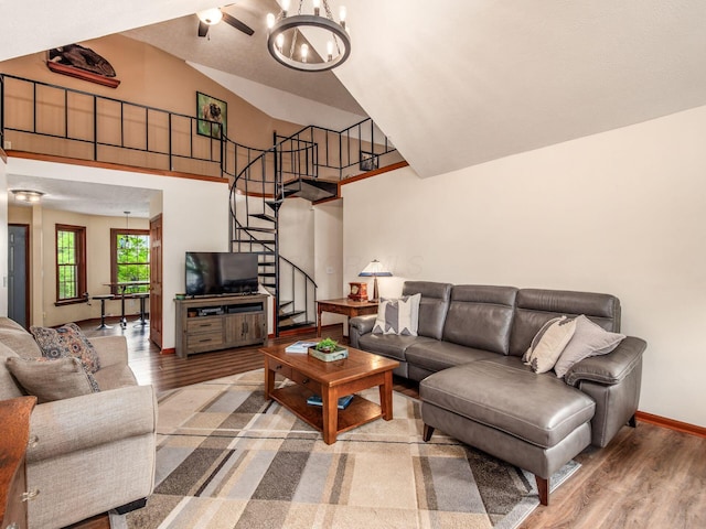 8120 Morgan Rd, West Jefferson, OH 43162 - living room with wood finished floors, stairway, a chandelier, and high vaulted ceiling