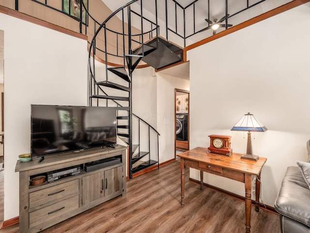 8120 Morgan Rd, West Jefferson, OH 43162 - living area featuring stairs, wood finished floors, a towering ceiling, and washer / dryer