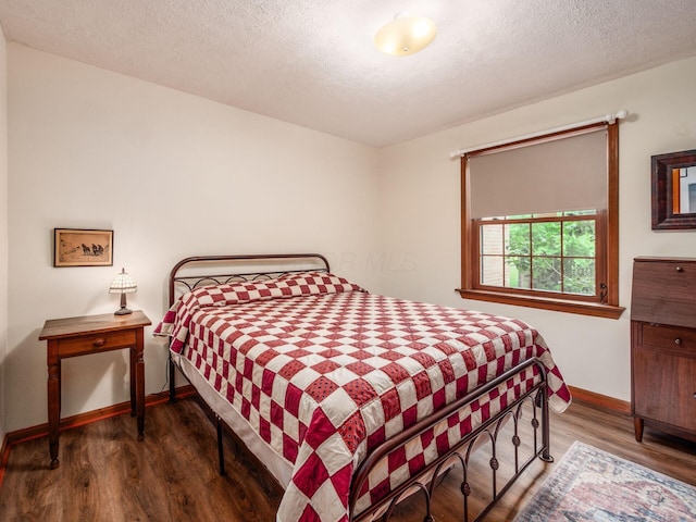 8120 Morgan Rd, West Jefferson, OH 43162 - bedroom with wood finished floors and a textured ceiling