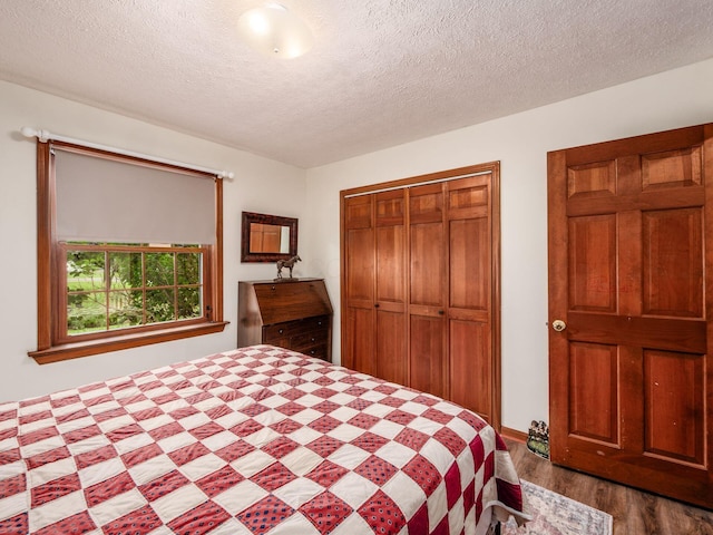 8120 Morgan Rd, West Jefferson, OH 43162 - bedroom featuring dark wood finished floors, a closet, and a textured ceiling