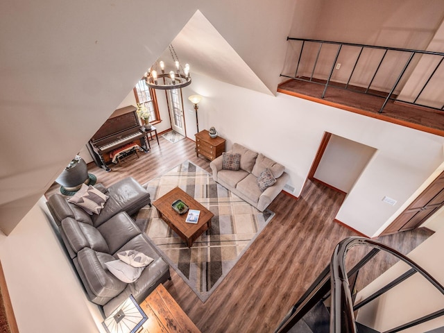 8120 Morgan Rd, West Jefferson, OH 43162 - living area featuring wood finished floors, a chandelier, and lofted ceiling