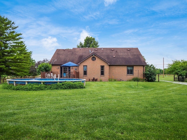 8120 Morgan Rd, West Jefferson, OH 43162 - rear view of property featuring an outdoor pool, brick siding, a yard, and a shingled roof