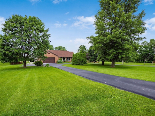 8120 Morgan Rd, West Jefferson, OH 43162 - view of front of home featuring a front yard, driveway, and a garage