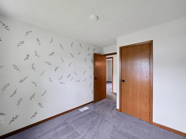 4629 Arnold Ave, Columbus, OH 43228 - unfurnished bedroom featuring carpet floors, a closet, and a textured ceiling