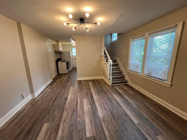 691-693 N Dawson Ave, Columbus, OH 43219 - unfurnished living room with stairs, dark wood-style floors, and a chandelier