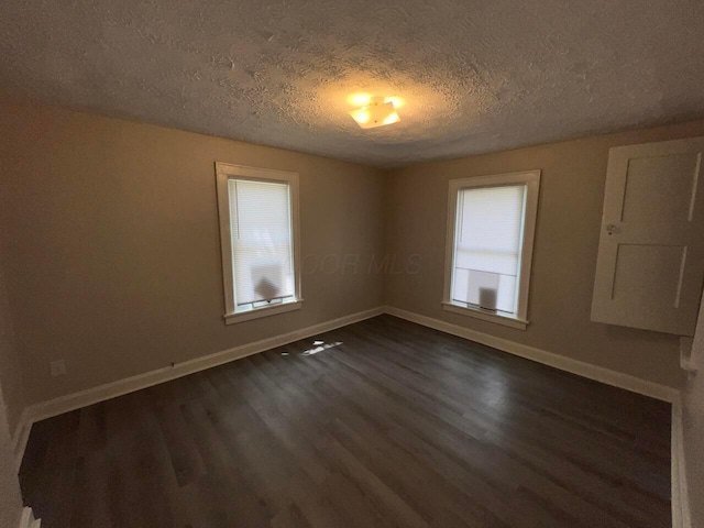 691-693 N Dawson Ave, Columbus, OH 43219 - empty room with dark wood finished floors, healthy amount of natural light, and a textured ceiling