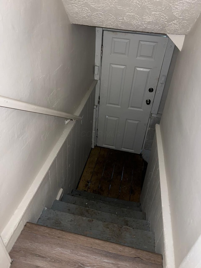 691-693 N Dawson Ave, Columbus, OH 43219 - stairway with a textured ceiling and wood finished floors