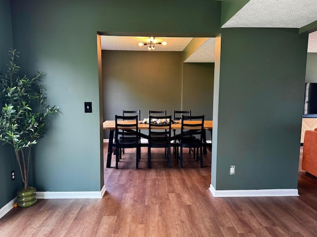 4227 Sestos Dr, Columbus, OH 43207 - dining room with wood finished floors, a textured ceiling, and a chandelier