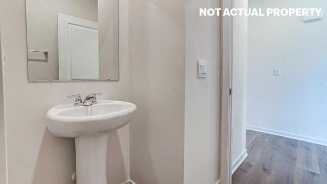 786 Sunny Vale Dr, Delaware, OH 43015 - bathroom with wood finished floors, baseboards, and a sink