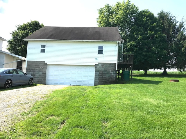 8023 County Road 30, Somerset, OH 43783 - view of side of property featuring driveway, a lawn, and a garage