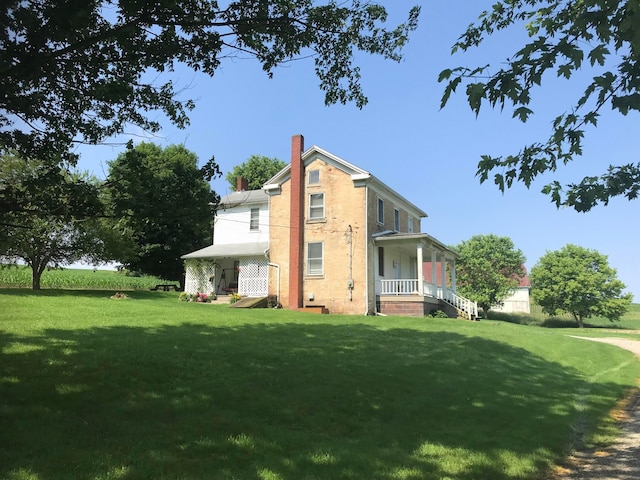 8023 County Road 30, Somerset, OH 43783 - rear view of property with a lawn, a chimney, brick siding, and a porch