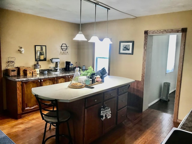 8023 County Road 30, Somerset, OH 43783 - kitchen with wood finished floors, a center island, pendant lighting, and a kitchen breakfast bar