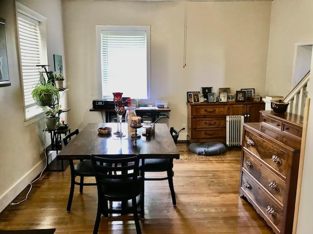 8023 County Road 30, Somerset, OH 43783 - dining space with radiator heating unit, wood finished floors, baseboards, and stairs