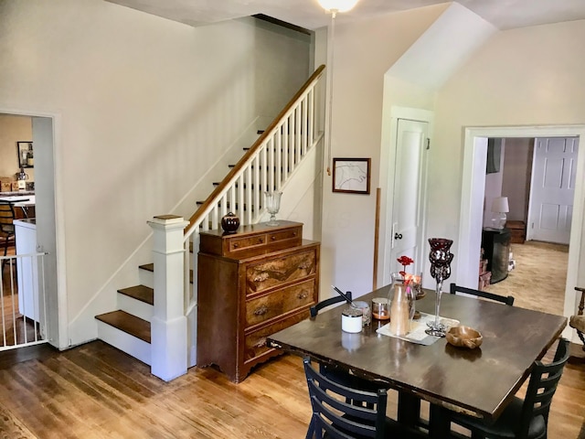 8023 County Road 30, Somerset, OH 43783 - dining space featuring stairs, wood finished floors, and vaulted ceiling