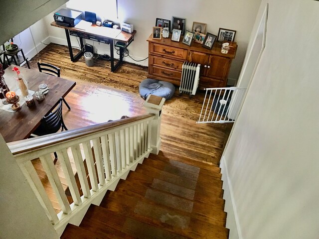 8023 County Road 30, Somerset, OH 43783 - staircase featuring radiator heating unit, wood finished floors, and baseboards