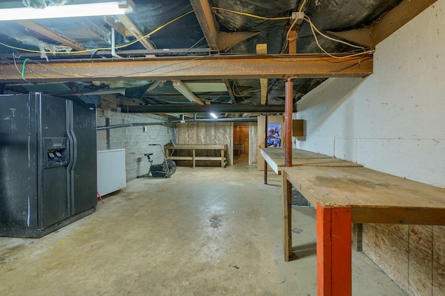 4137 Dry Run Rd, Chillicothe, OH 45601 - unfinished below grade area featuring black fridge with ice dispenser and washer / dryer