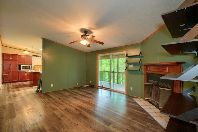 4137 Dry Run Rd, Chillicothe, OH 45601 - unfurnished living room featuring light wood finished floors, ornamental molding, ceiling fan, a textured ceiling, and lofted ceiling