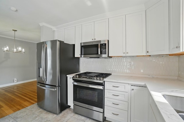 33 W Dominion Blvd, Columbus, OH 43214 - kitchen with appliances with stainless steel finishes, a chandelier, light tile patterned floors, light stone counters, and white cabinets