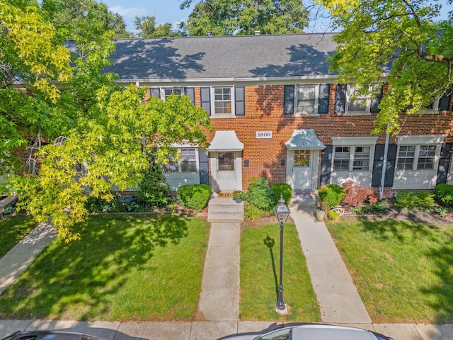 1809 NW Ct Unit C, Columbus, OH 43212 - view of front of home featuring a front lawn, brick siding, and a shingled roof