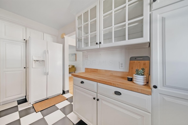 1809 NW Ct Unit C, Columbus, OH 43212 - kitchen featuring white fridge with ice dispenser, wood counters, tile patterned floors, glass insert cabinets, and white cabinets