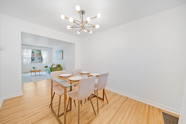 1809 NW Ct Unit C, Columbus, OH 43212 - dining area with light wood finished floors and a chandelier