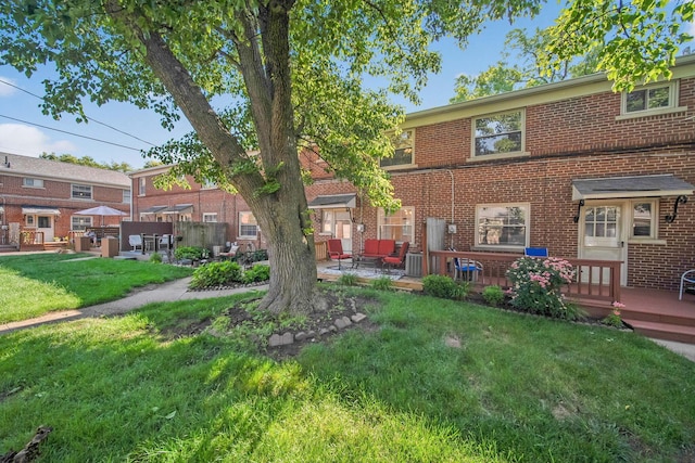 1809 NW Ct Unit C, Columbus, OH 43212 - rear view of house featuring a lawn, brick siding, a patio, and a wooden deck