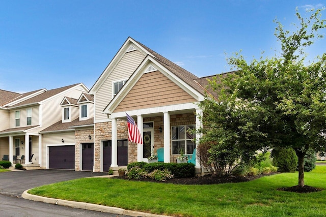 4724 Trademark Trl, Hilliard, OH 43026 - view of front of home with driveway, a front yard, stone siding, and a garage