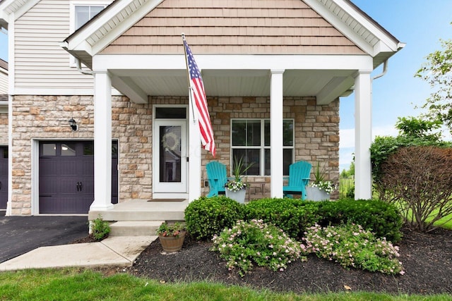4724 Trademark Trl, Hilliard, OH 43026 - property entrance with stone siding, asphalt driveway, and covered porch