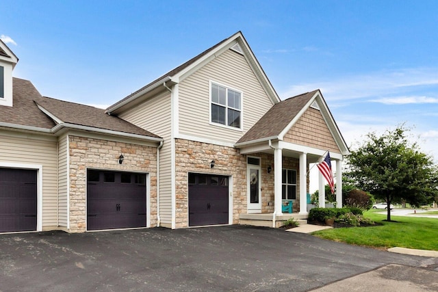 4724 Trademark Trl, Hilliard, OH 43026 - view of front of house featuring stone siding, asphalt driveway, roof with shingles, and a front yard