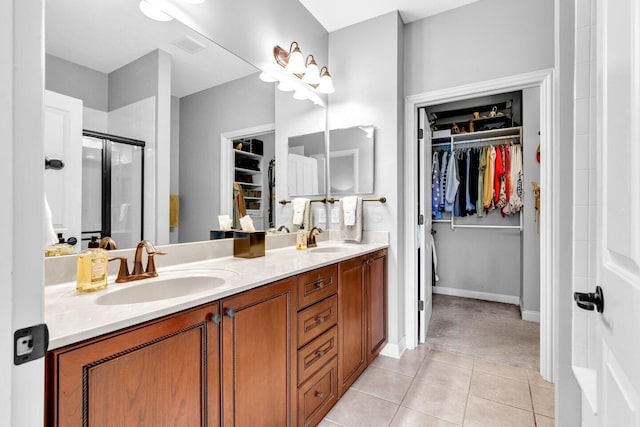 4724 Trademark Trl, Hilliard, OH 43026 - bathroom with a walk in closet, double vanity, tile patterned flooring, and a stall shower
