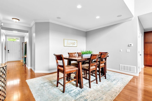 4724 Trademark Trl, Hilliard, OH 43026 - dining area featuring light wood finished floors, baseboards, crown molding, and recessed lighting