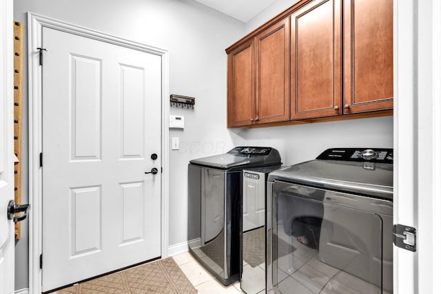 4724 Trademark Trl, Hilliard, OH 43026 - laundry room featuring separate washer and dryer, cabinet space, baseboards, and light tile patterned floors