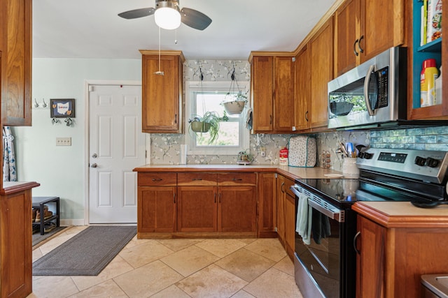 3720 N Waggoner Rd, Blacklick, OH 43004 - kitchen with appliances with stainless steel finishes, backsplash, brown cabinets, and ceiling fan