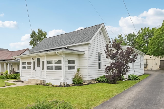 45 S Main St, New Holland, OH 43145 - view of front of house with roof with shingles and a front lawn