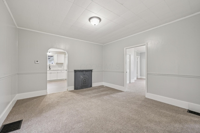 45 S Main St, New Holland, OH 43145 - carpeted empty room with ornamental molding, arched walkways, baseboards, and a sink