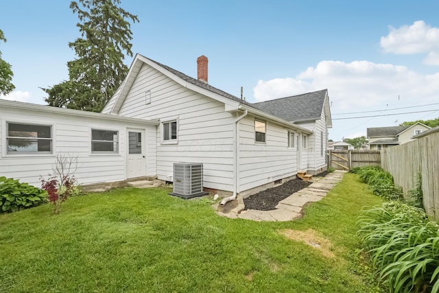45 S Main St, New Holland, OH 43145 - rear view of property with central AC, a chimney, roof with shingles, and entry steps