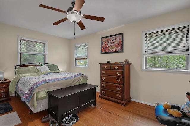 5990 Roselawn Ave, Columbus, OH 43232 - bedroom with light wood-style floors, multiple windows, and baseboards