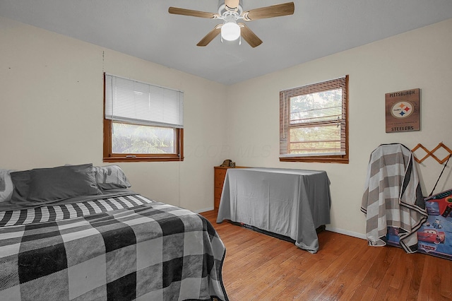 5990 Roselawn Ave, Columbus, OH 43232 - bedroom with light wood-type flooring, a ceiling fan, and baseboards