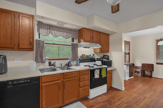5990 Roselawn Ave, Columbus, OH 43232 - kitchen with dishwasher, electric range oven, a sink, under cabinet range hood, and light countertops