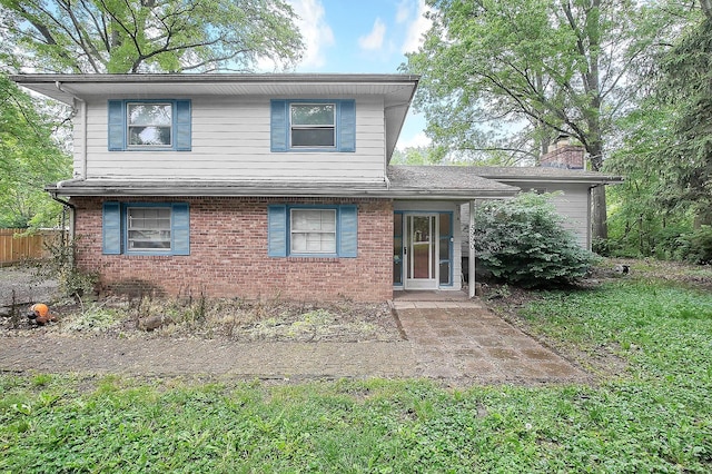5990 Roselawn Ave, Columbus, OH 43232 - view of front of property featuring a chimney, brick siding, and a patio area