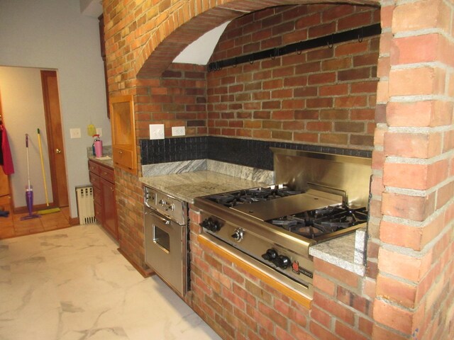 470 Beacon Rd, Newark, OH 43055 - kitchen with radiator, stainless steel gas stovetop, light countertops, and oven