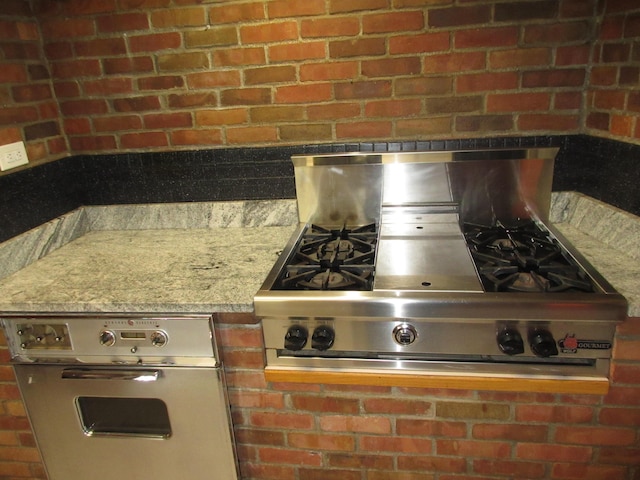 470 Beacon Rd, Newark, OH 43055 - kitchen view of wall oven, stainless steel gas stovetop, and brick wall