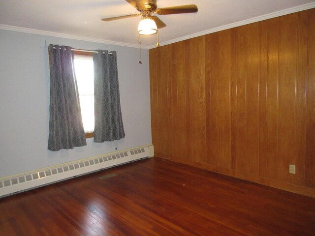470 Beacon Rd, Newark, OH 43055 - empty room featuring baseboard heating, hardwood / wood-style floors, a ceiling fan, and crown molding