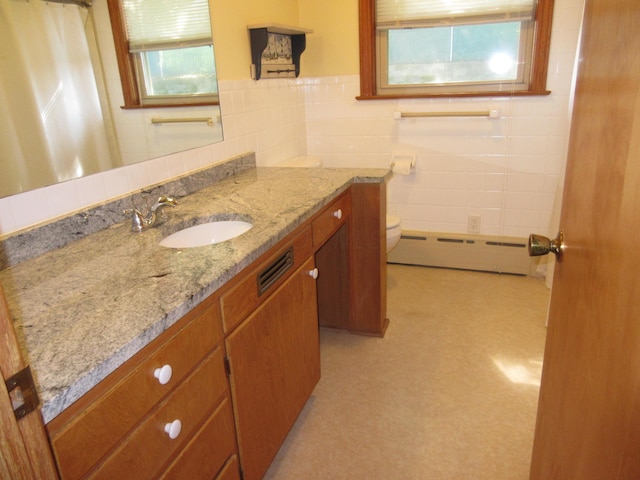 470 Beacon Rd, Newark, OH 43055 - full bathroom featuring a baseboard radiator, tile walls, toilet, vanity, and curtained shower