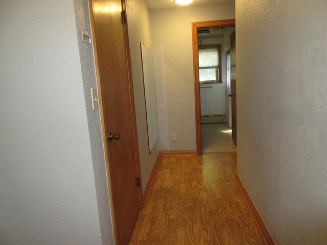 470 Beacon Rd, Newark, OH 43055 - corridor with a baseboard heating unit, light wood-type flooring, and baseboards