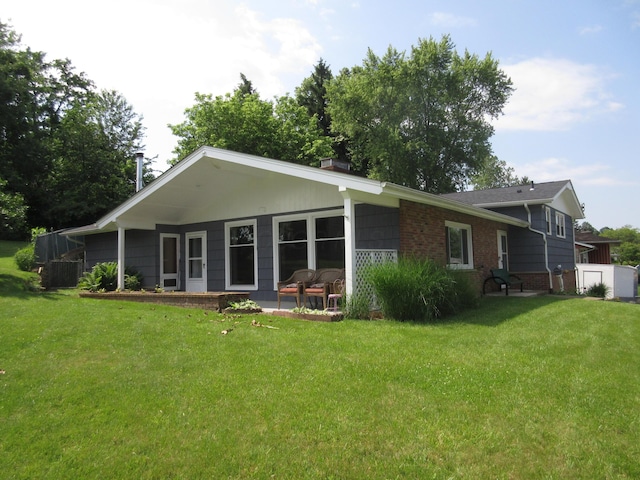 470 Beacon Rd, Newark, OH 43055 - rear view of property with a yard, brick siding, a chimney, and a patio