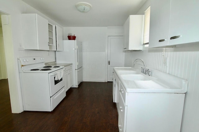 552 Southwood Ave, Columbus, OH 43207 - kitchen featuring white appliances, dark wood-style floors, a wainscoted wall, white cabinets, and light countertops
