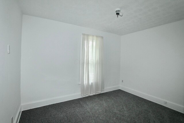 552 Southwood Ave, Columbus, OH 43207 - spare room with dark carpet and a textured ceiling