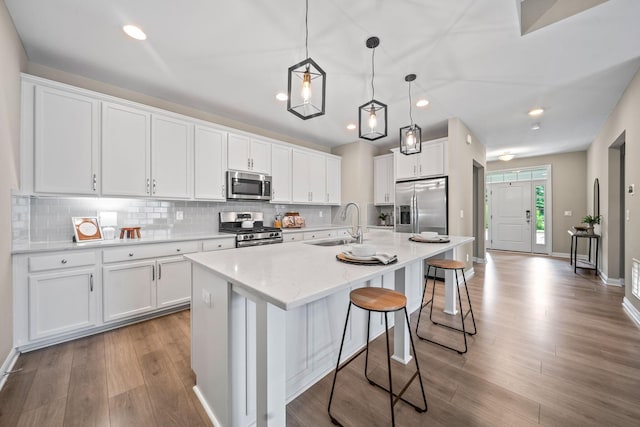 5508 Camlin Pl W Unit 48, Westerville, OH 43081 - kitchen featuring appliances with stainless steel finishes, wood finished floors, backsplash, white cabinets, and recessed lighting