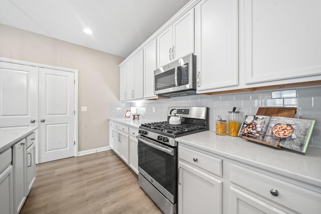 5508 Camlin Pl W Unit 48, Westerville, OH 43081 - kitchen featuring appliances with stainless steel finishes, white cabinetry, tasteful backsplash, light wood-type flooring, and recessed lighting